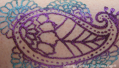 Brush, and rinse excess glitter from 'white henna'